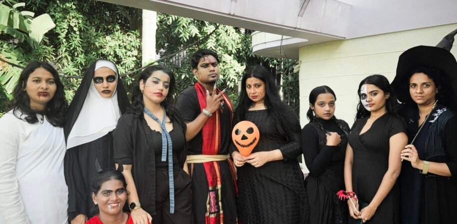 Students and faculty posing together in Halloween costumes at Halloween Fest INSD Trivandrum